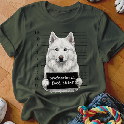 White husky with blue eyes holding a "professional food thief" sign in mugshot style.