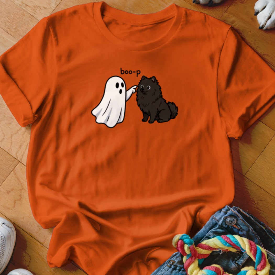 Orange t-shirt with cartoon ghost saying "boo-p" to a black Pomeranian.