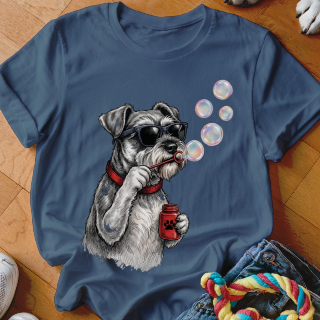 A dark blue t-shirt printed with a graphic of a schnauzer wearing sunglasses and blowing soap bubbles.