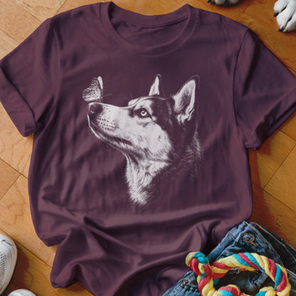 A dark purple t-shirt featuring a white sketch graphic of a husky looking at a butterfly on its nose.