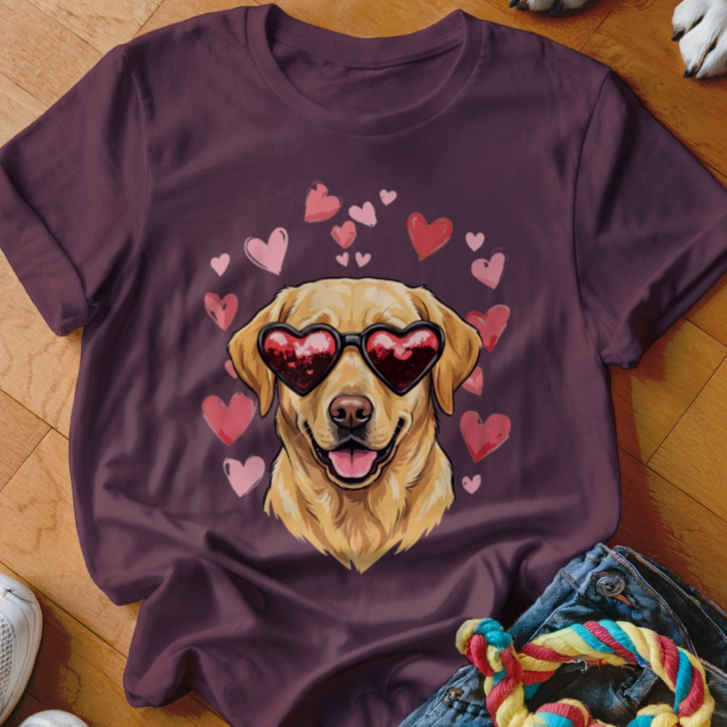 Plum-colored t-shirt featuring a golden retriever wearing heart-shaped sunglasses surrounded by pink and red hearts.