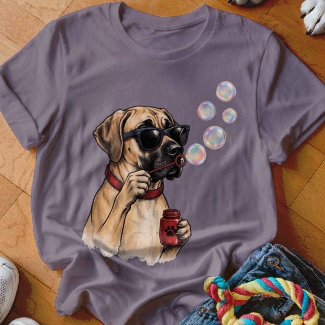 A mauve t-shirt features a graphic of a tan dog wearing sunglasses blowing bubbles.