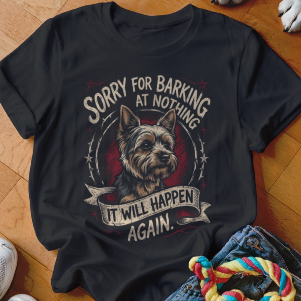 A black short-sleeved t-shirt featuring a graphic of a Yorkshire terrier and the text SORRY FOR BARKING AT NOTHING IT WILL HAPPEN AGAIN.