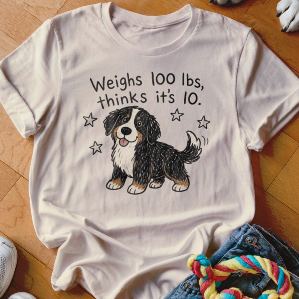 T-shirt with text "Weighs 100 lbs, thinks it's 10" and cartoon dog.
