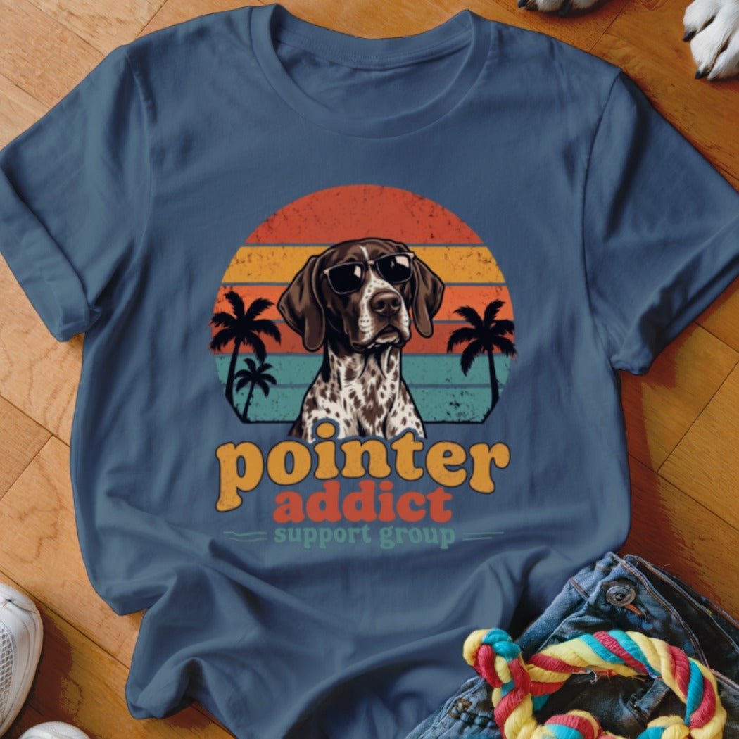 A blue t-shirt featuring a retro sunset graphic, a German Shorthaired Pointer in sunglasses, and text reading Pointer Addict Support Group.