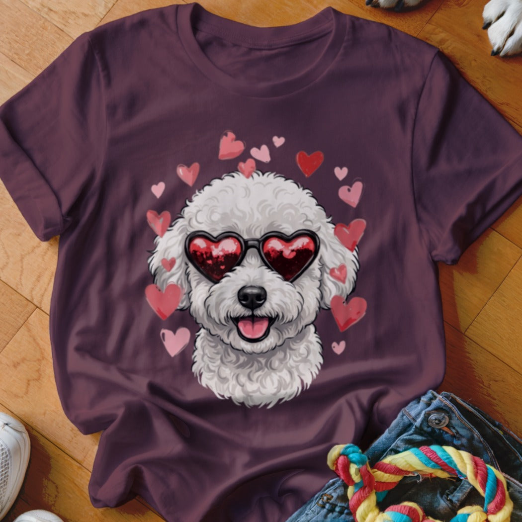 Maroon t-shirt featuring a graphic of a white poodle wearing heart-shaped sunglasses surrounded by floating pink hearts.