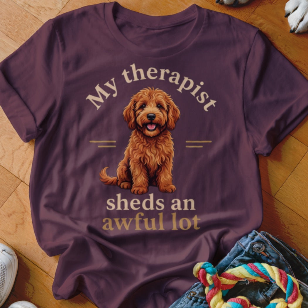 Maroon t-shirt with a doodle dog graphic and text "My therapist sheds an awful lot."