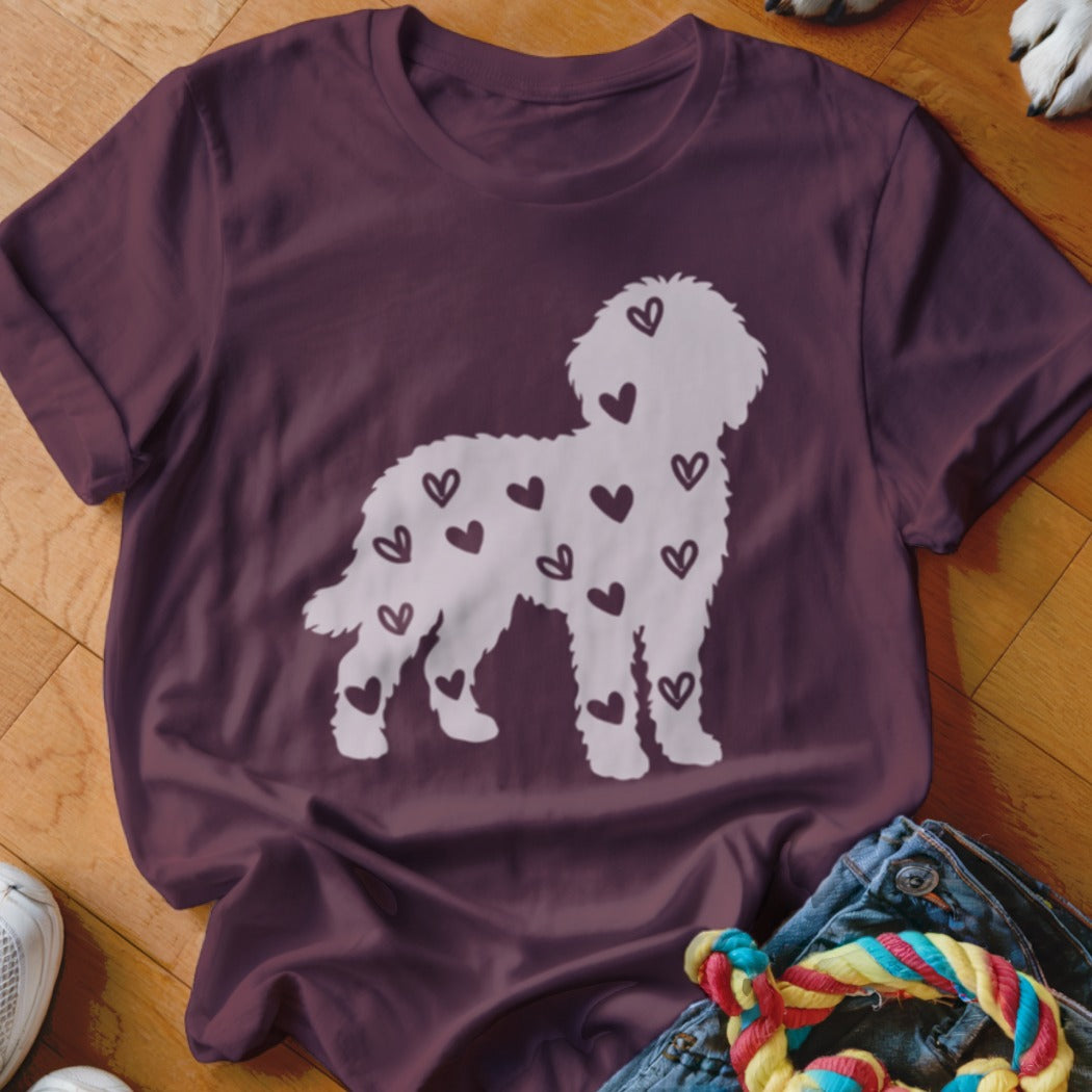 Maroon t-shirt with white silhouette of a fluffy dog covered in hearts.