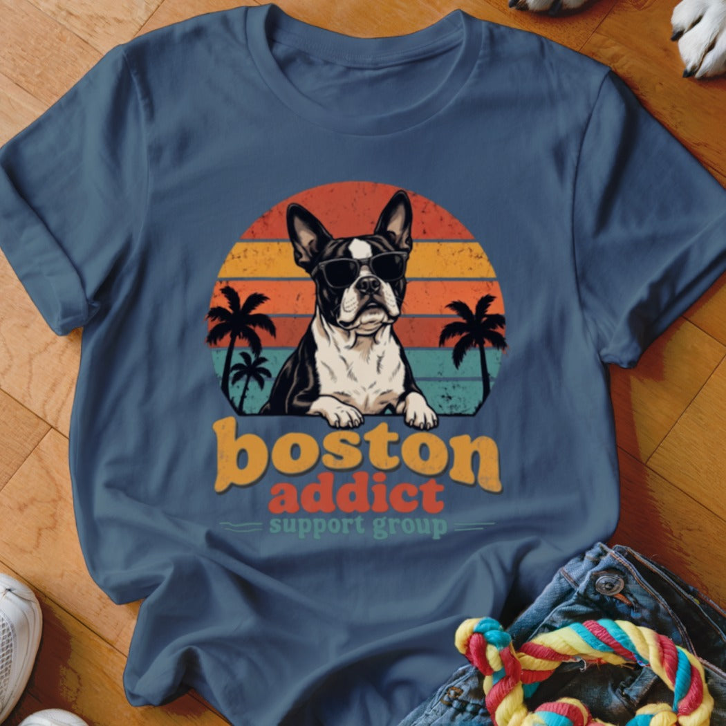 Blue crewneck t-shirt featuring a retro graphic of a Boston Terrier wearing sunglasses before a sunset.