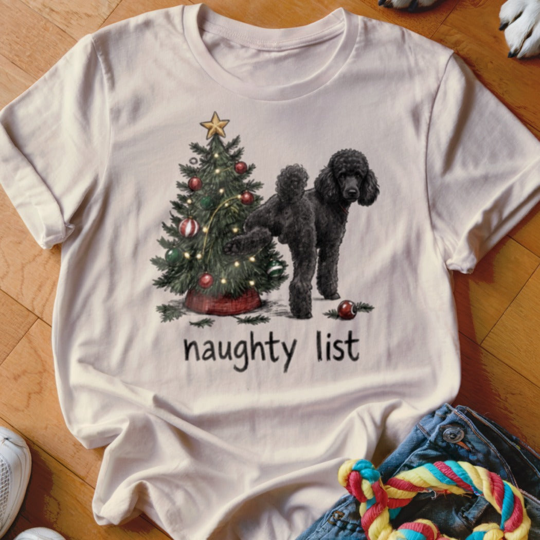 Black poodle with Christmas tree and "naughty list" text on a cream t-shirt.