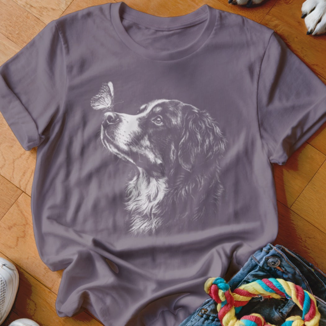 Mauve crewneck t-shirt featuring a white line drawing of a dog looking at a butterfly on its nose.