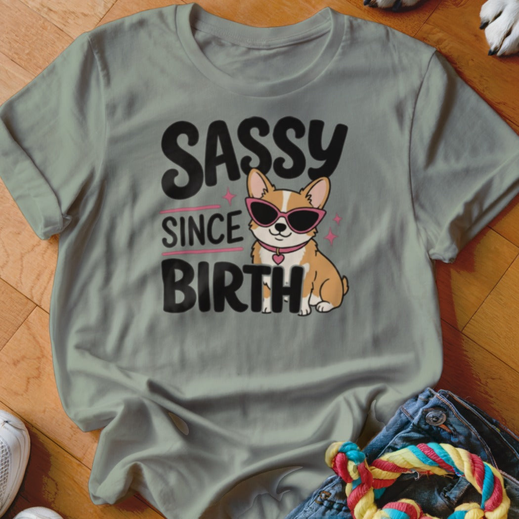 Corgi wearing sunglasses on a t-shirt with "Sassy Since Birth" text.