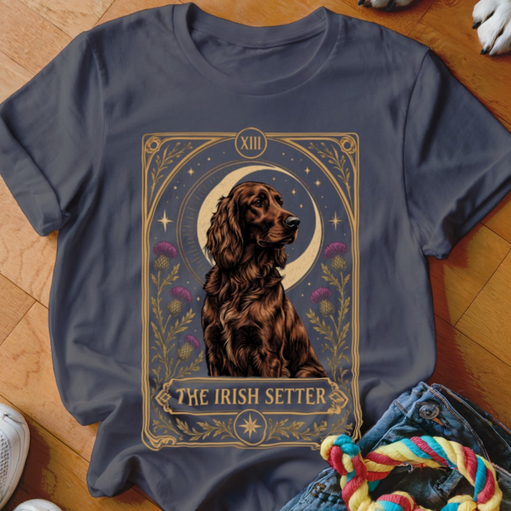 A dark gray t-shirt features a tarot-style graphic of an Irish Setter dog framed by a crescent moon, stars, and thistles with text reading THE IRISH SETTER.