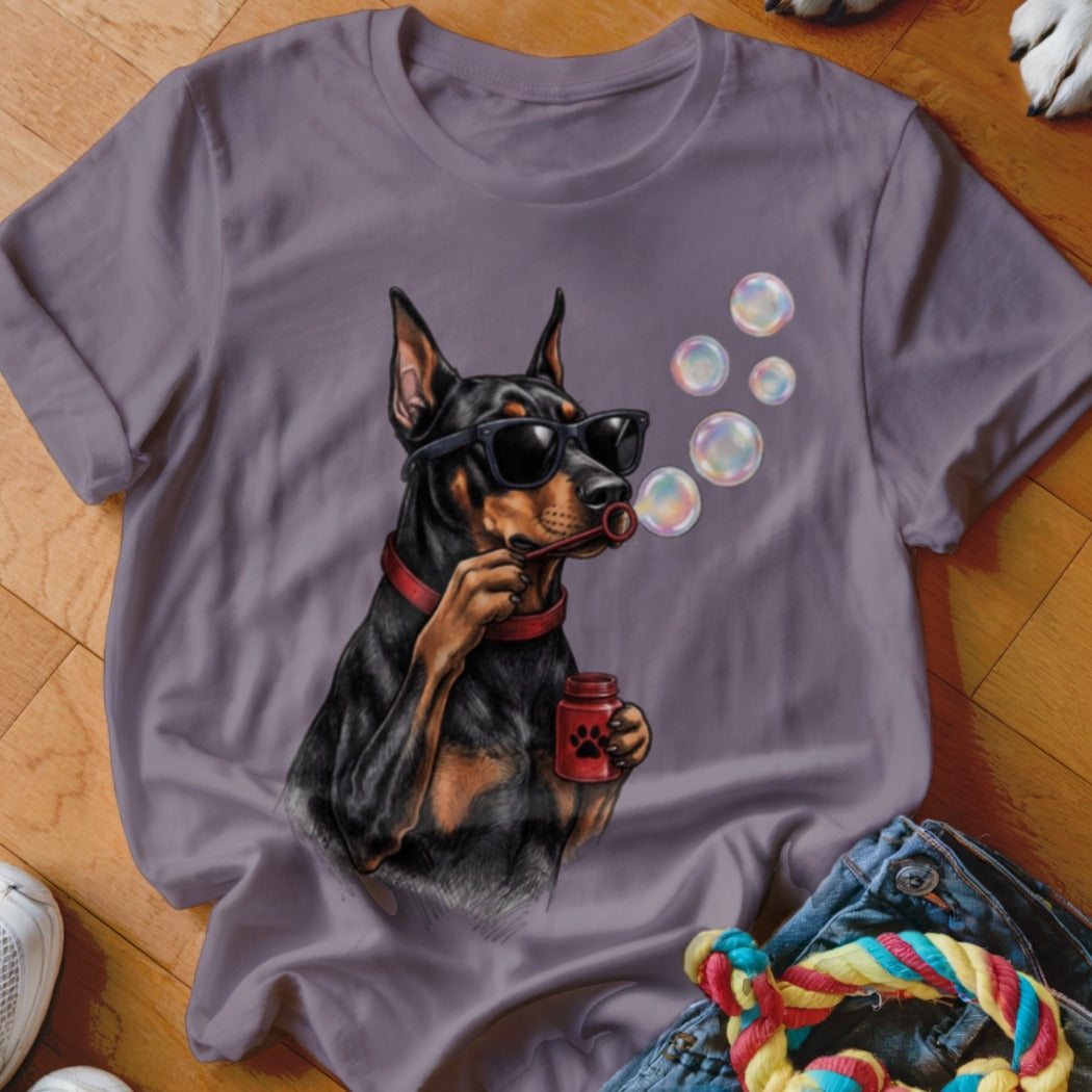 Purple crewneck t-shirt featuring a Doberman Pinscher wearing sunglasses and blowing soap bubbles.