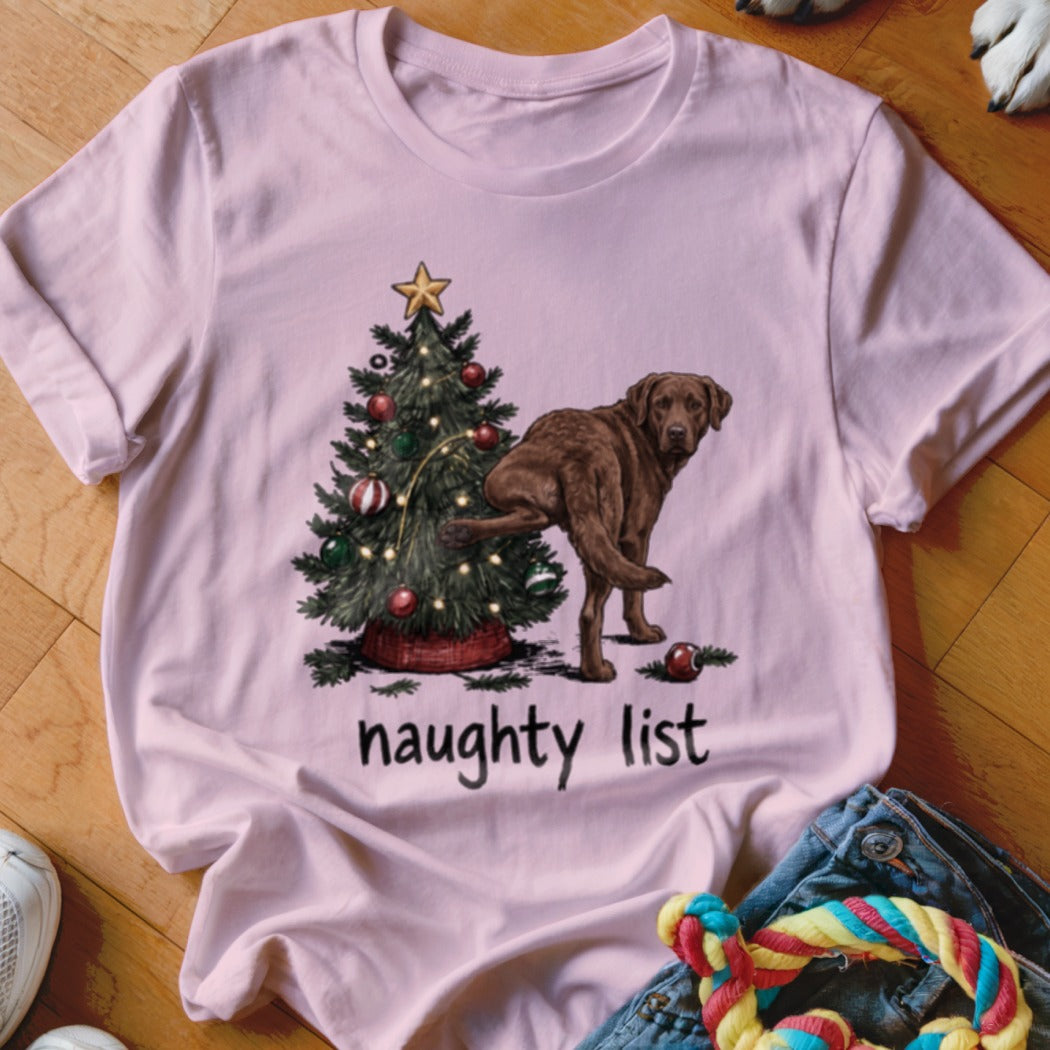 Pink t-shirt with a Christmas tree and a chocolate lab, text says "naughty list".