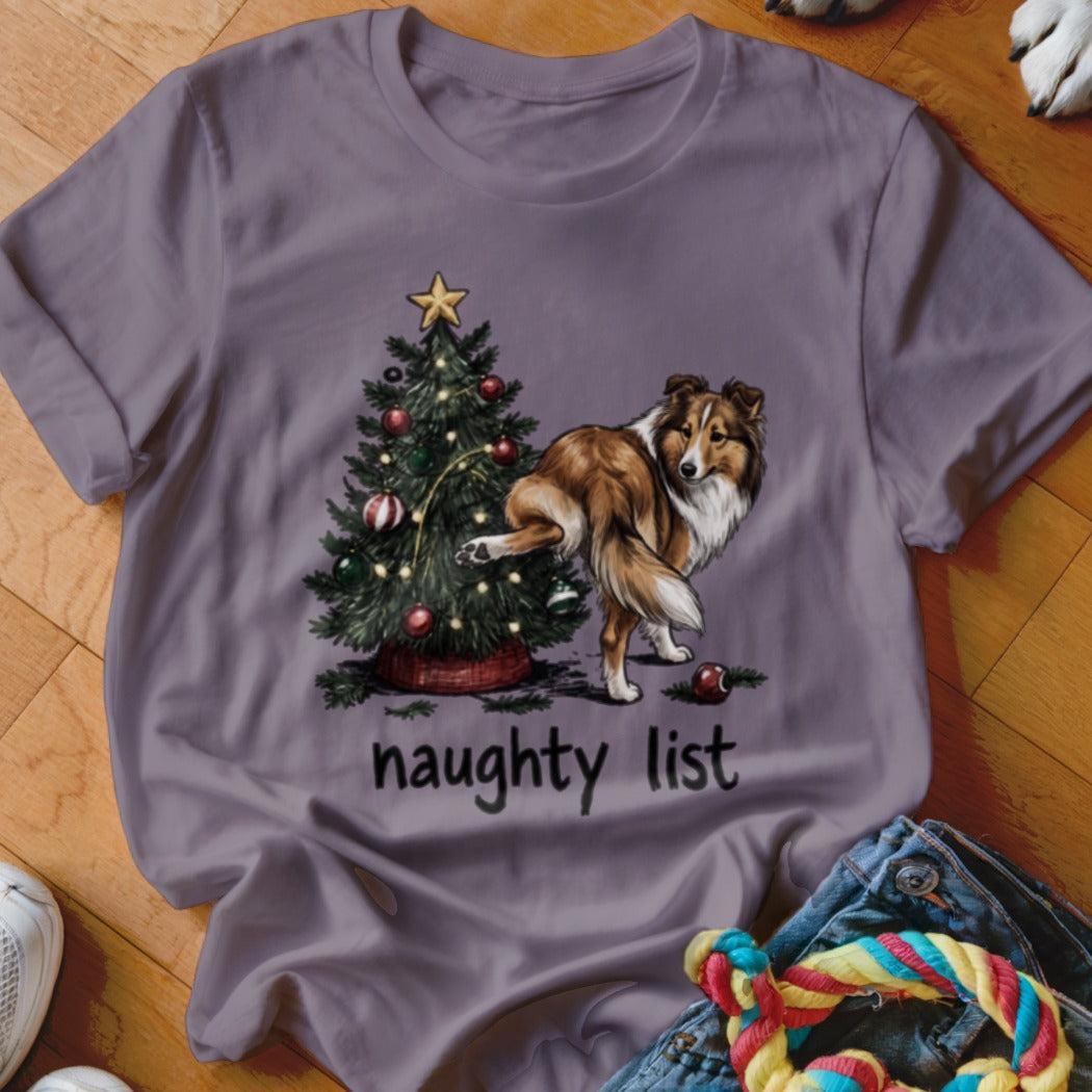 Sheltie dog next to Christmas tree with text "naughty list".