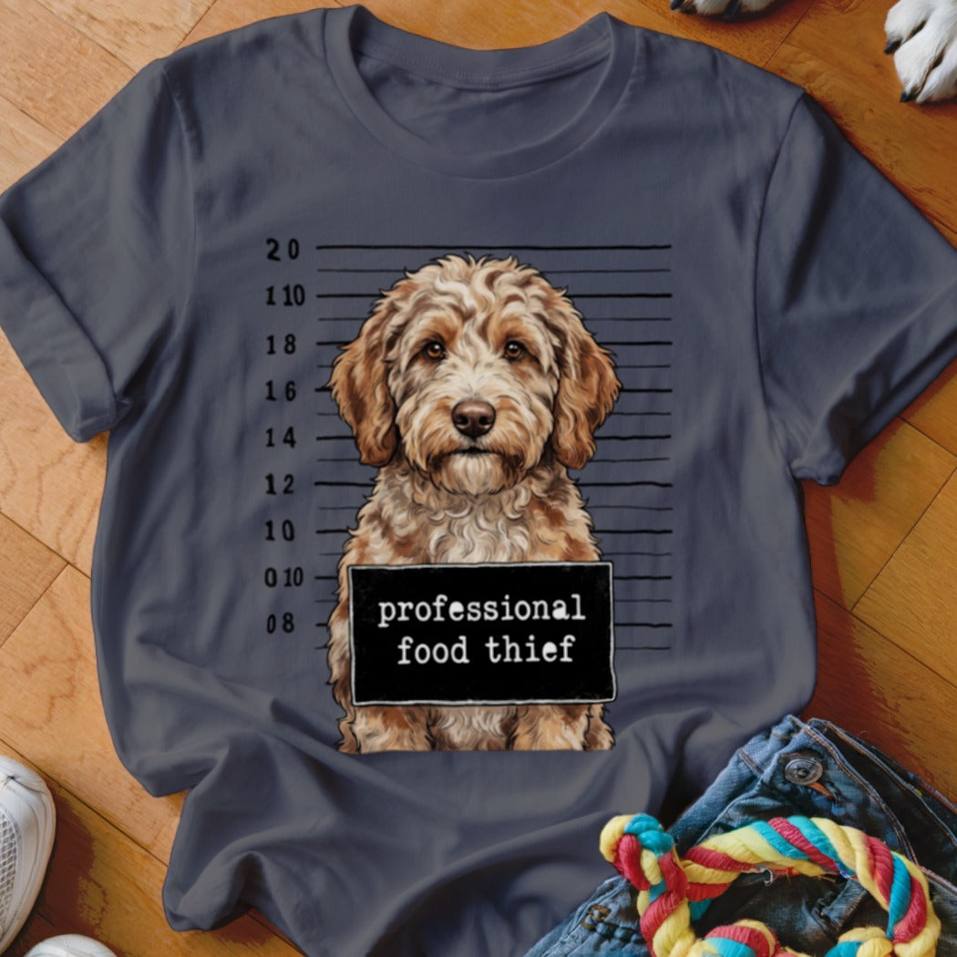 Goldendoodle dog mugshot with "professional food thief" text on sign.