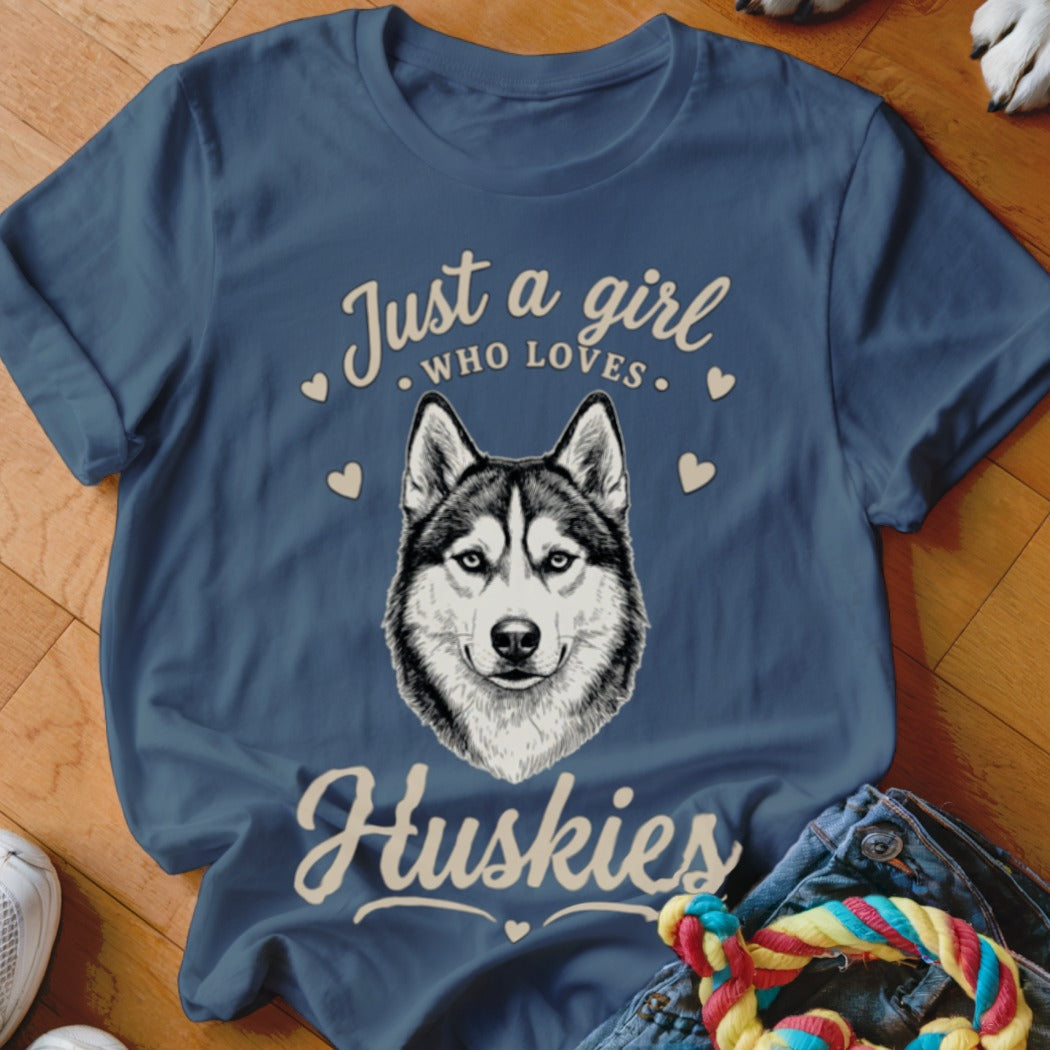 Blue t-shirt featuring a husky graphic and the text Just a girl who loves Huskies surrounded by small hearts.