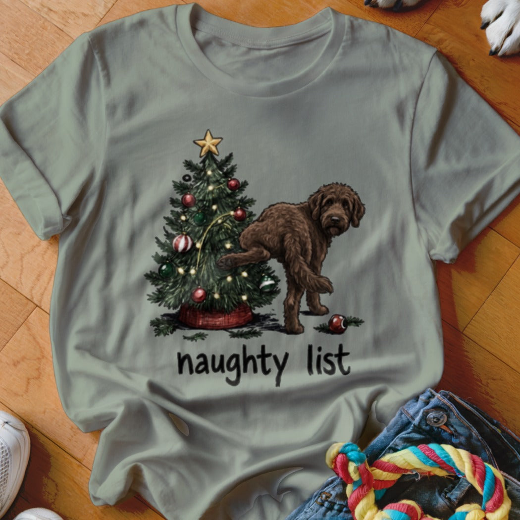 Brown dog lifting leg on Christmas tree with "naughty list" text.