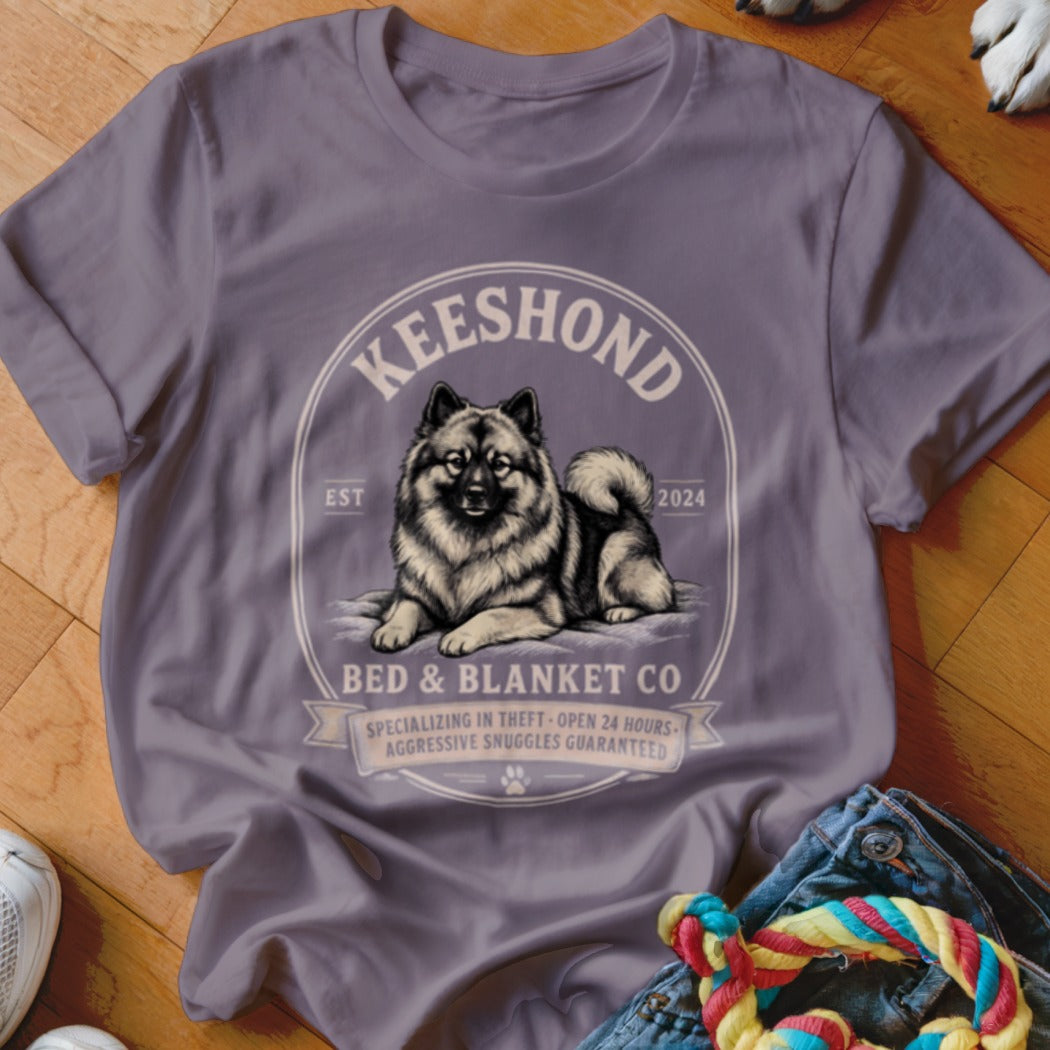 Keeshond dog graphic on a grey t-shirt with text "Bed & Blanket Co".