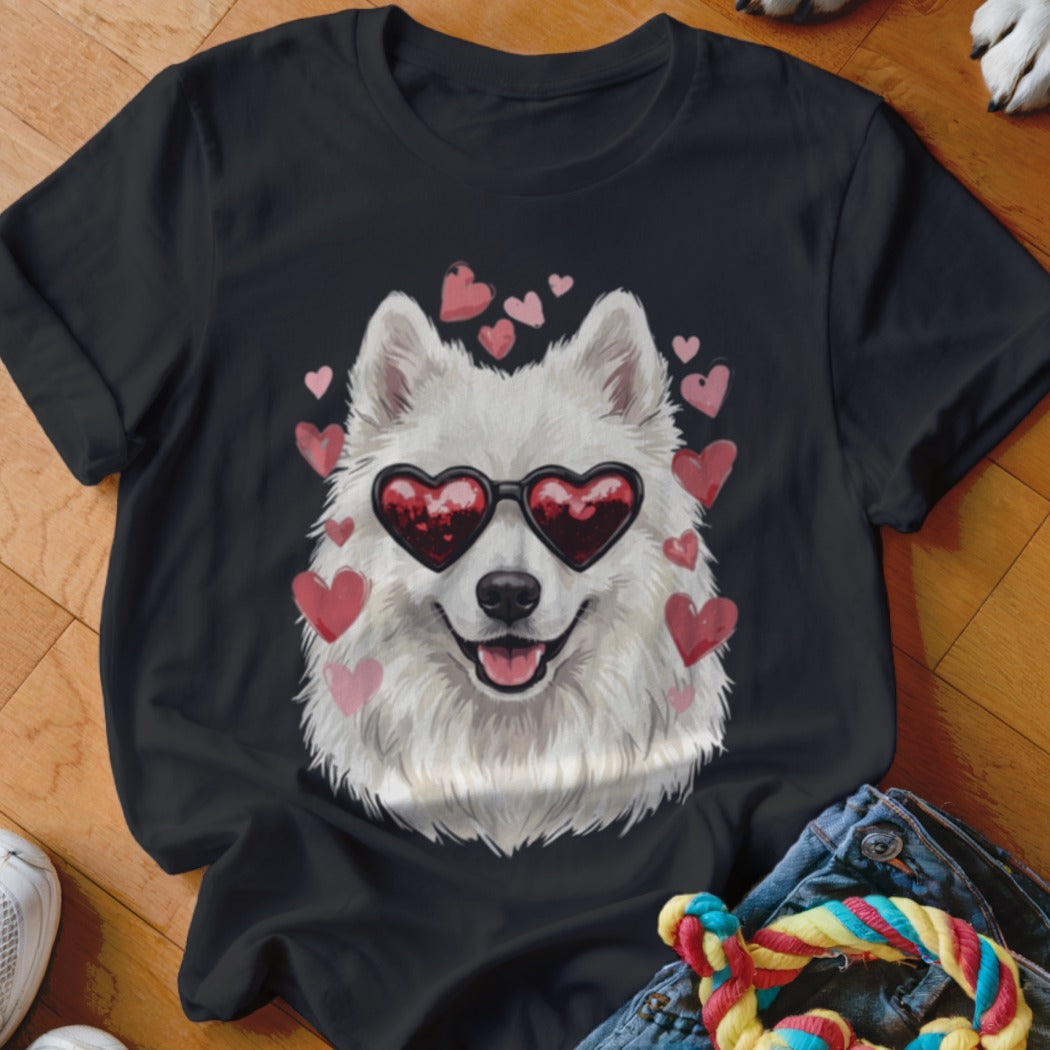 Black t-shirt featuring a graphic of a white fluffy dog wearing heart-shaped sunglasses surrounded by pink hearts.