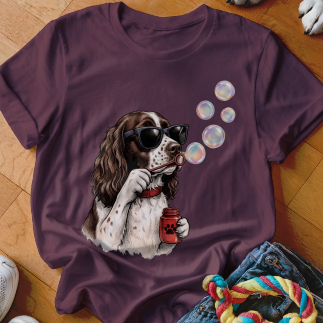 Maroon crewneck t-shirt featuring an illustration of an English Springer Spaniel wearing sunglasses and blowing bubbles.