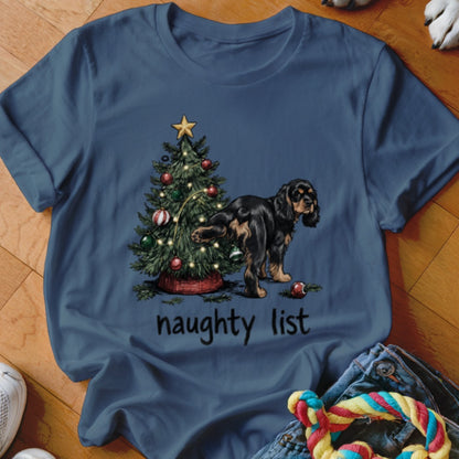 Black and tan dog peeing on a Christmas tree with "naughty list" text.