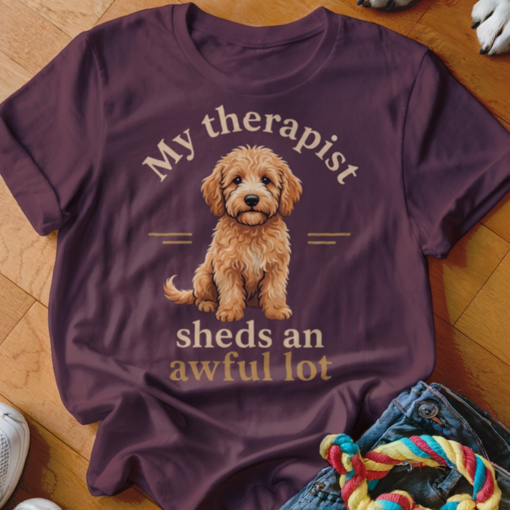 Maroon t-shirt with a goldendoodle graphic and text "My therapist sheds an awful lot".