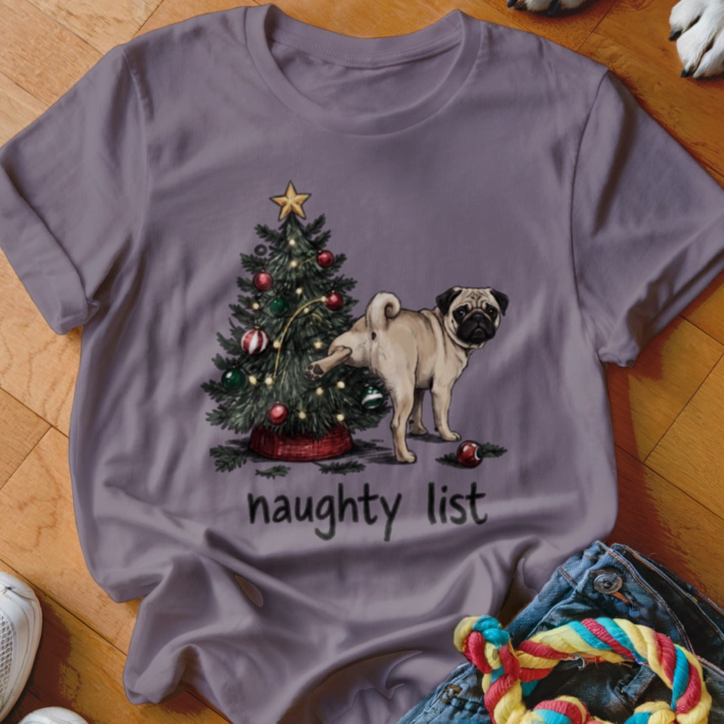 Purple t-shirt featuring a pug lifting its leg against a decorated Christmas tree, with the text naughty list underneath.