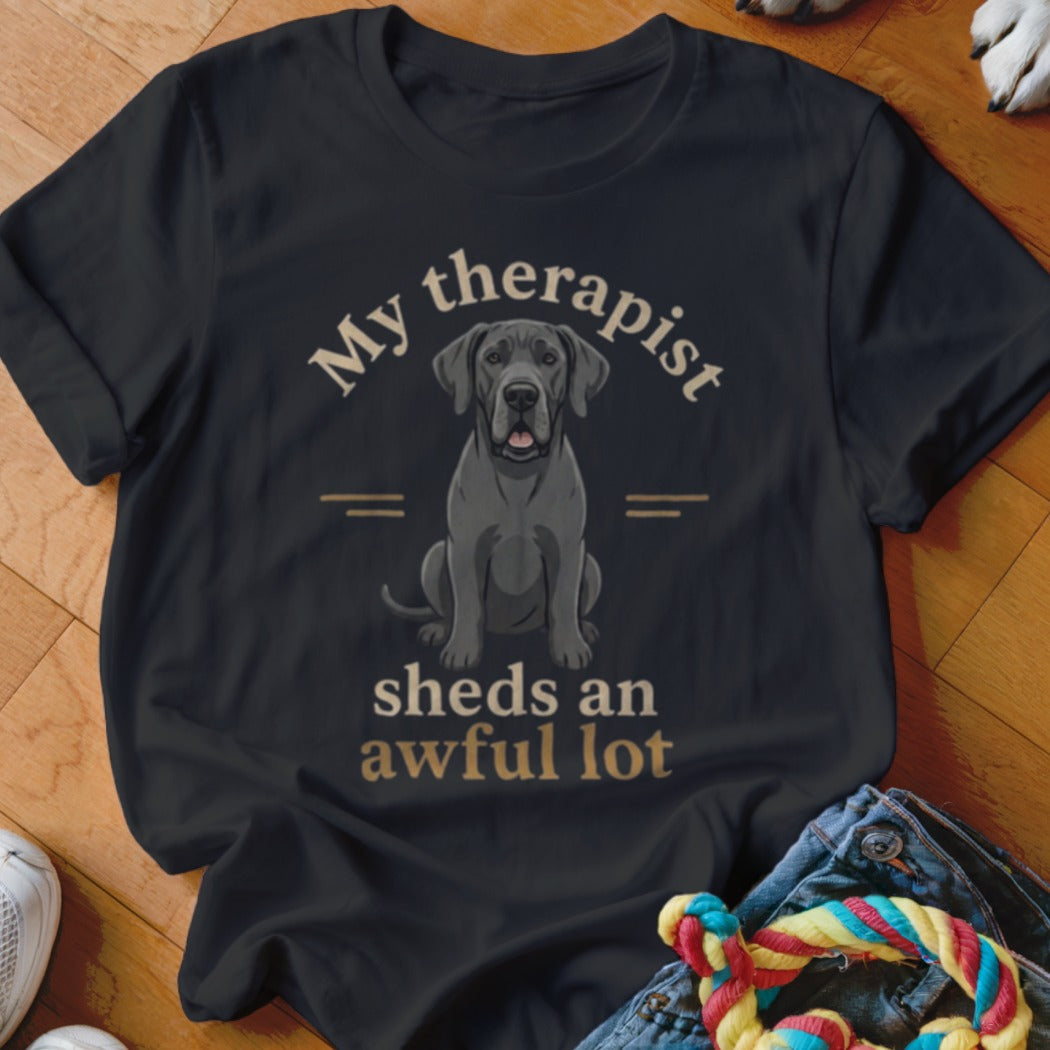 Black t-shirt with graphic of a Great Dane and text "My therapist sheds an awful lot".