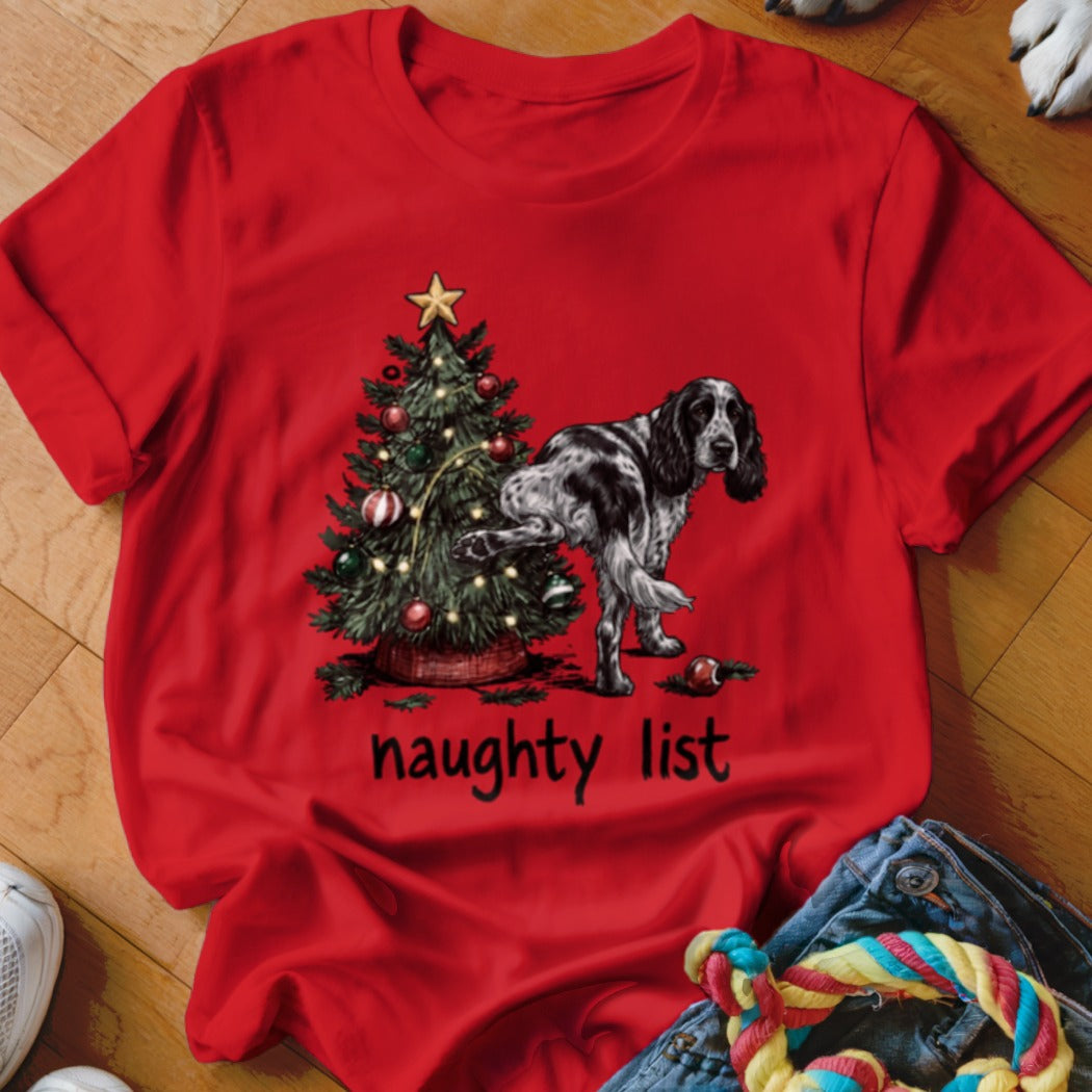 Black and white dog peeing on Christmas tree with "naughty list" text.
