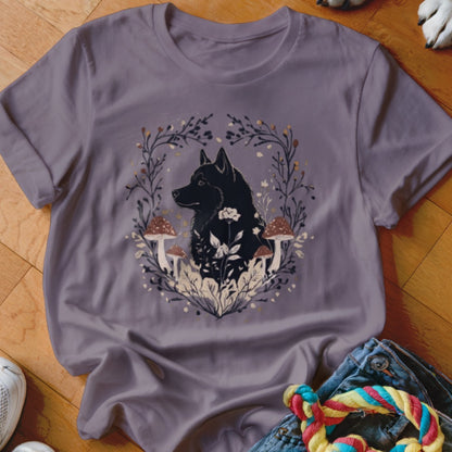 A purple crewneck t-shirt featuring a graphic of a black dog surrounded by mushrooms and foliage.