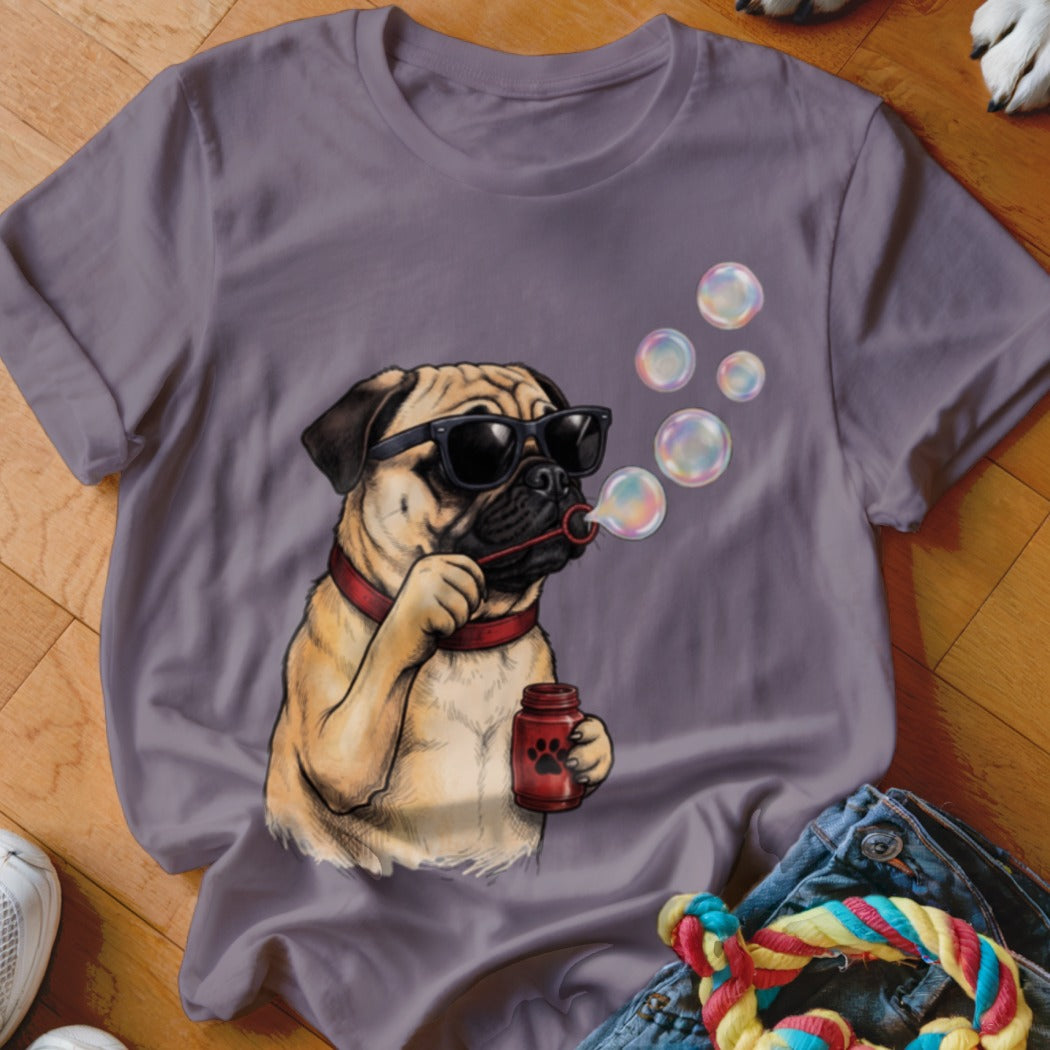 A purple t-shirt featuring a graphic of a pug wearing sunglasses and blowing soap bubbles.
