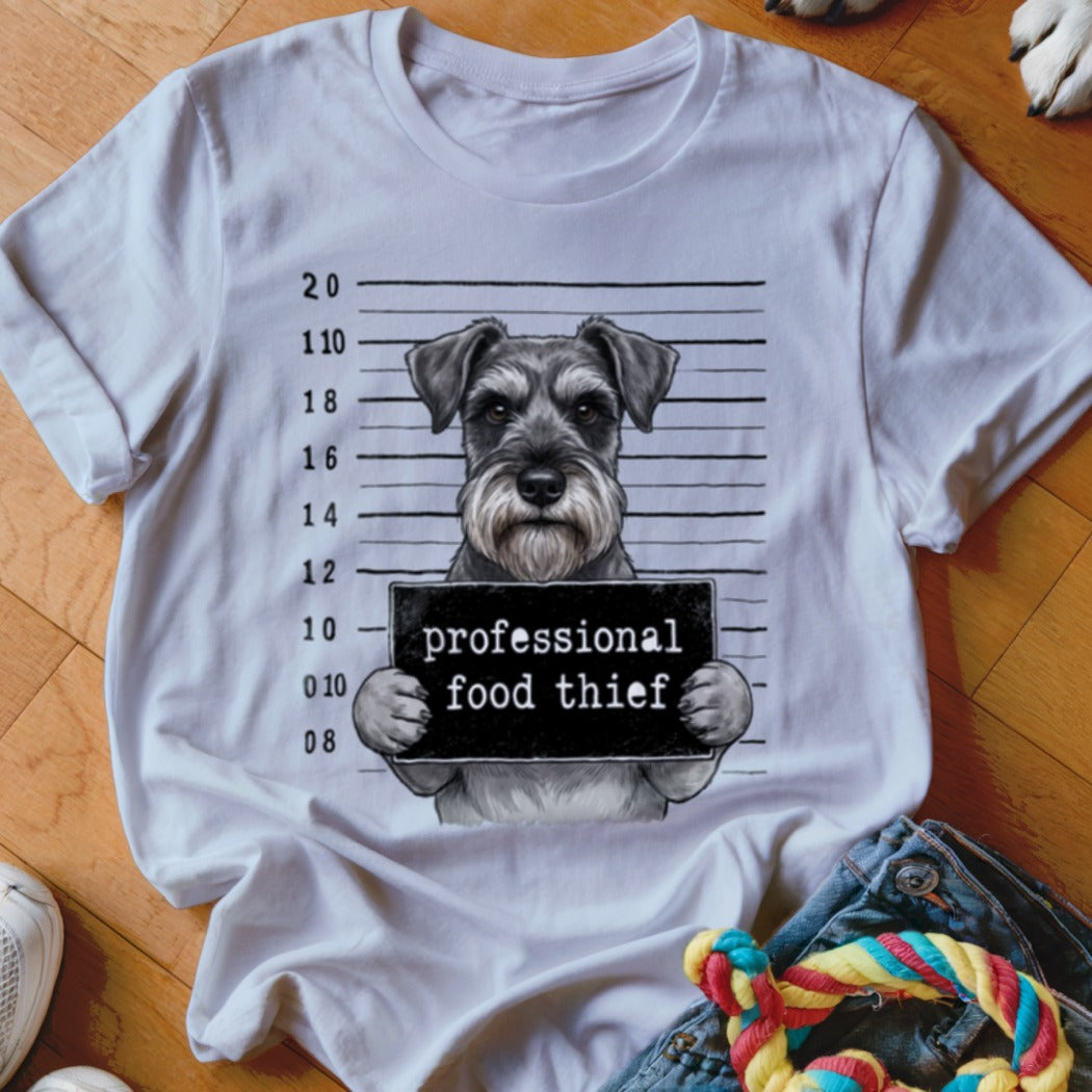 Schnauzer mugshot with text "professional food thief" on a white t-shirt.