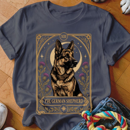 A charcoal grey t-shirt featuring a tarot card graphic of a German Shepherd with purple flowers and a crescent moon.