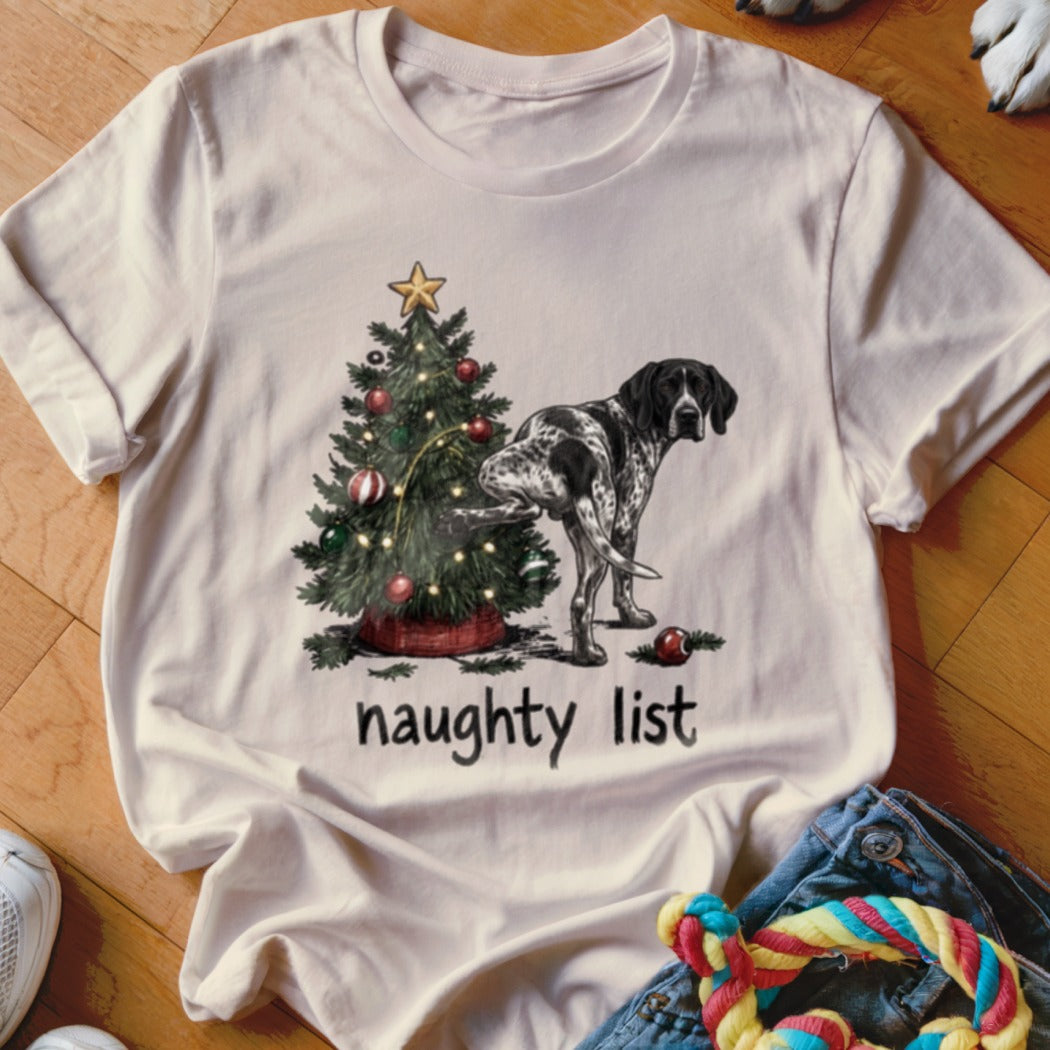 T-shirt with a dog peeing on a Christmas tree and "naughty list" text.