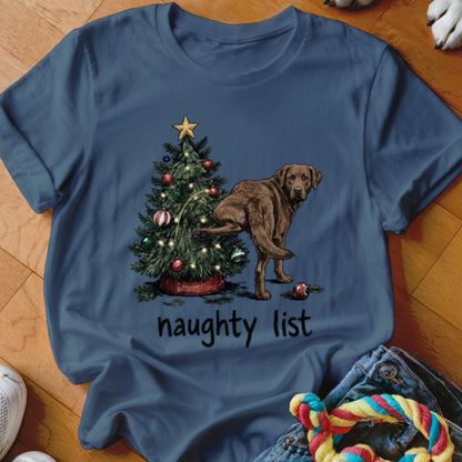 Brown dog lifting leg near Christmas tree with text "naughty list".