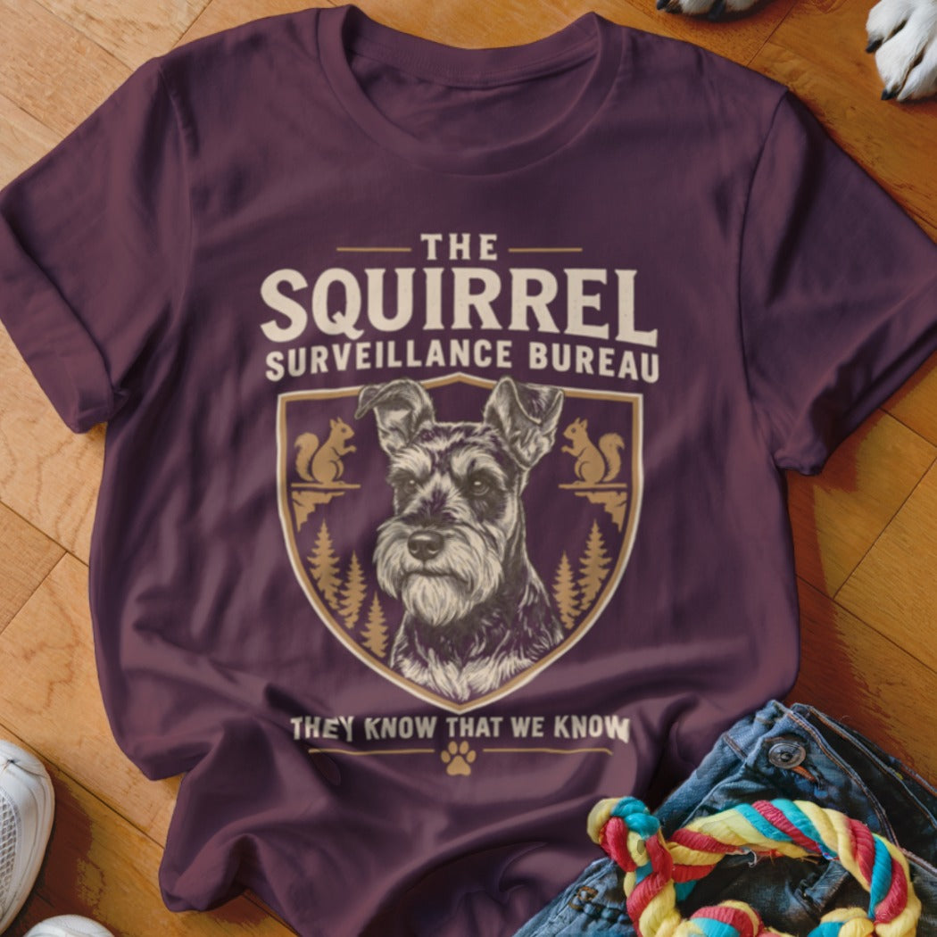 Maroon crewneck t-shirt featuring a graphic of a Schnauzer and text reading The Squirrel Surveillance Bureau.