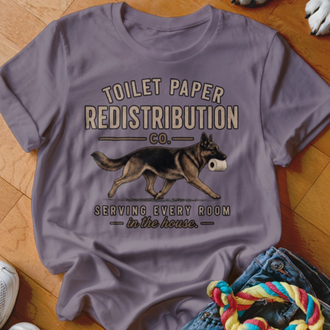 German Shepherd carrying toilet paper with "Toilet Paper Redistribution Co." text.