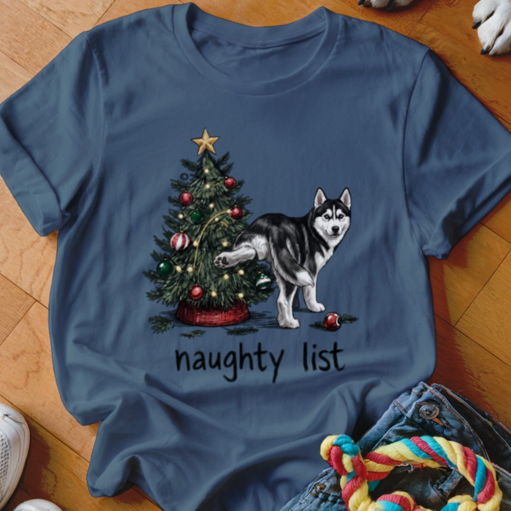 A dark blue t-shirt featuring a graphic of a husky urinating on a Christmas tree with the text naughty list.