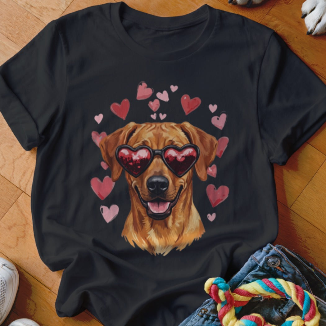 A black t-shirt features a graphic of a golden retriever wearing heart-shaped sunglasses surrounded by pink hearts.