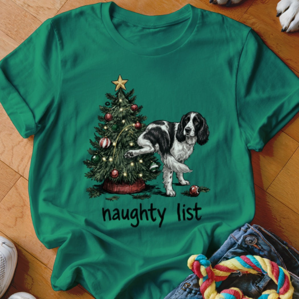 Black and white dog near a Christmas tree, text says "naughty list".