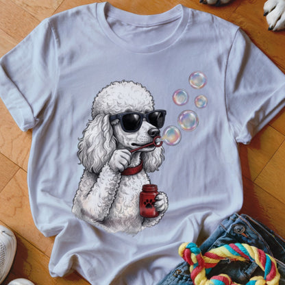 White t-shirt featuring an illustration of a poodle wearing sunglasses and blowing soap bubbles.