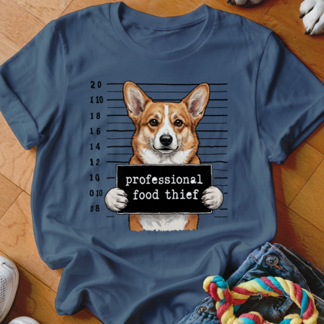 Corgi dog mugshot with sign that reads "professional food thief"
