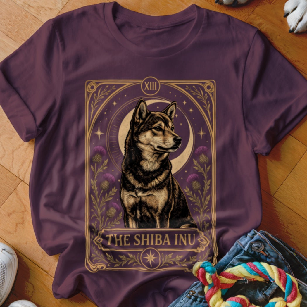 Maroon t-shirt featuring a tarot-style graphic of a Shiba Inu, crescent moon, and purple flowers.