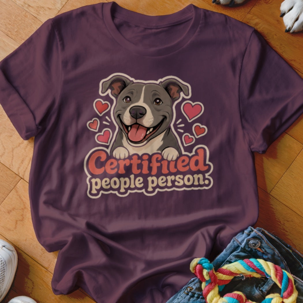 Purple t-shirt with a smiling pit bull illustration and the text "Certified people person".