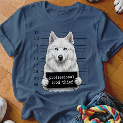 Blue t-shirt with a white husky in a mugshot holding a sign that reads "professional food thief".