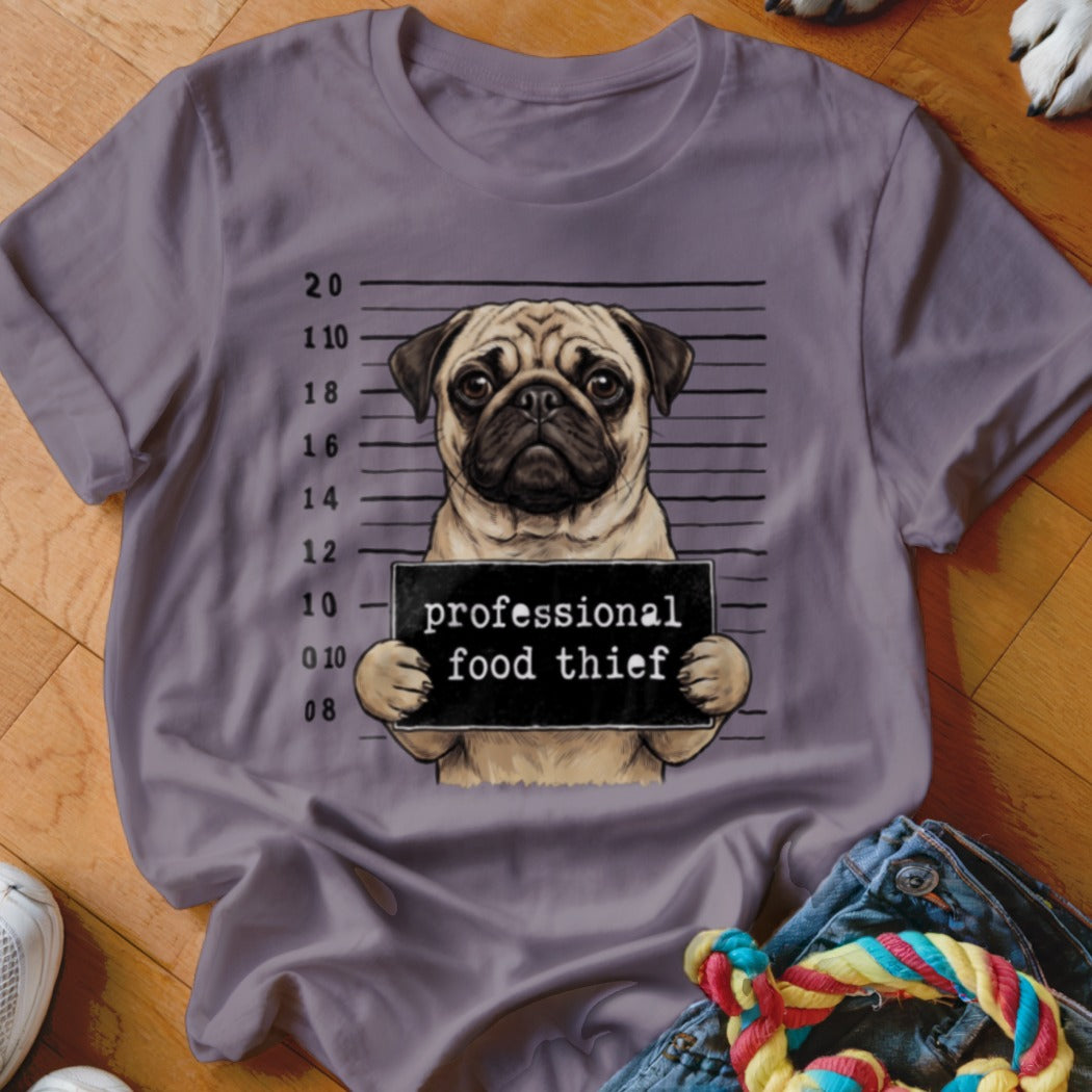 Pug in mugshot holding a "professional food thief" sign.