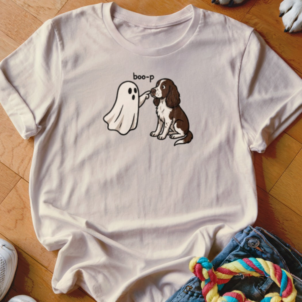 White t-shirt with cartoon ghost "boop-ing" a brown and white dog.