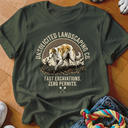 Green t-shirt with a graphic of a Borzoi dog and text "Unsolicited Landscaping Co. Fast Excavations. Zero Permits."